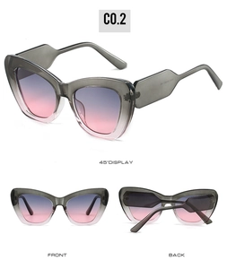 Detail view of cat eye sunglasses with grey translucent frame and purple gradient lenses