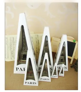 Macro detail of bronze Eiffel Tower metal models in various sizes with Paris gift boxes