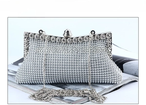 Detail of silver rhinestone evening clutch bag with crystal frame and chain strap