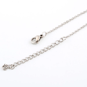 Macro detail of stainless steel lobster clasp and adjustable O-chain for necklace