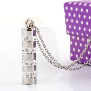 Macro view of silver stainless steel cylinder pendant with sparkling crystal rows
