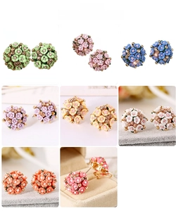 Macro detail of multicolored rose flower earrings with center crystal and ceramic petals