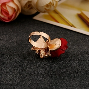 Detailed view of an adjustable golden ring featuring a 3D red rose with petal textures