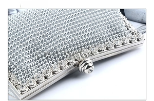 Detailed top view of silver evening clutch featuring rhinestones and beaded texture