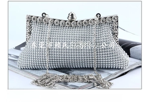 Detail of silver evening clutch bag featuring a detachable chain with anti-drop hooks