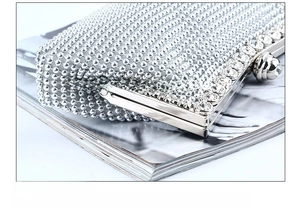 Detailed macro view of electroplated stainless steel frame on silver beaded evening clutch