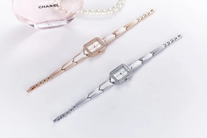 Close-up of rectangular quartz watches with diamond-set bezels and metal link bands
