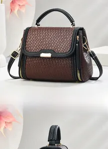 Detail showing woven texture in brown and black with golden hardware on a tote bag