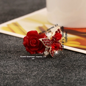 Detailed close-up showing dimensions of the red rose and butterfly ring decoration