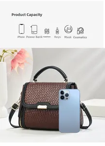 Detail showing high capacity of brown woven tote bag with size reference to a smartphone