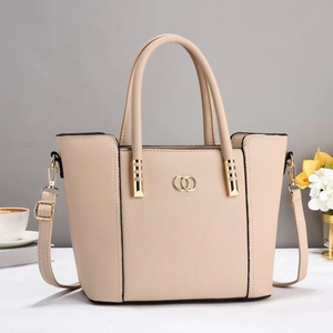Detail of beige litchi grain texture and gold ring buckle on high-end tote bag
