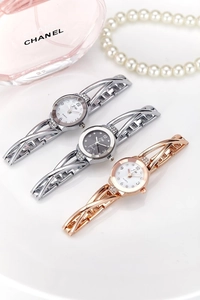 Detail of luxury rhinestone-set quartz watches with stylish hollow bracelet bands