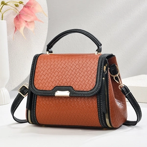 Elegant brown woven tote bag with top handle, gold hardware and adjustable strap