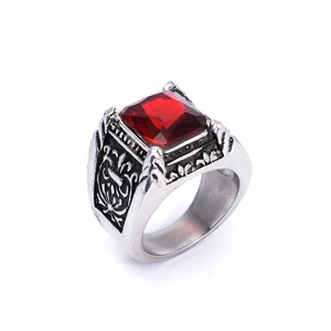 Macro shot of detailed floral carvings on vintage stainless steel ruby ring band