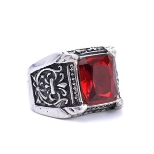 Close-up of vintage steel ring featuring a large red square-cut ruby and embossed patterns