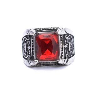 Macro detail of royal vintage steel ring featuring a large red ruby gemstone inlay