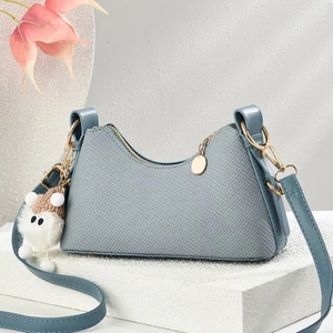 Sac bandoulière en jean bleu avec finitions en cuir et chaîne dorée en studio moderne