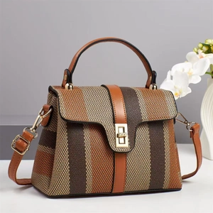 Chic multi-color striped canvas handbag with leather straps and gold metal lock detail