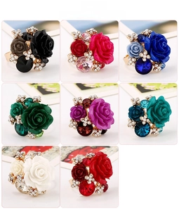 Detail view of colorful resin rose rings with crystals in eight vibrant floral shades