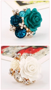 Detail of layered resin rose ring with embedded crystals and gold-plated adjustable band