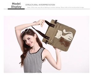 Detailed view of khaki canvas tote bag featuring cute cat embroidery and brown woven handles