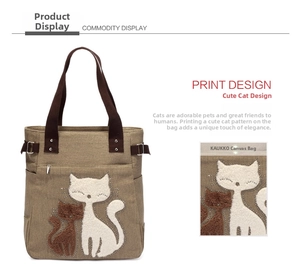 Detail of khaki canvas tote bag featuring embroidered cats and adjustable side buckles