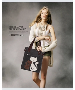 Detail of grey canvas tote with cat embroidery and adjustable metal D-ring buckle