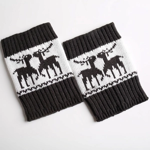 Detailed view of knitted leg warmers featuring reindeer jacquard and ribbed cuffs