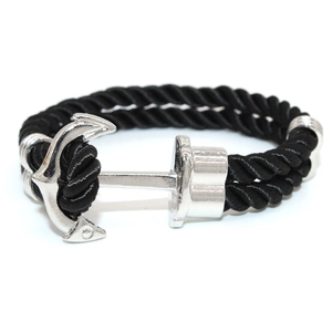 Close-up of black braided nautical rope bracelet with silver anchor metal clasp detail