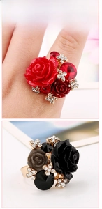 Detail of flower rings with resin rose petals and sparkling rhinestones on golden bands