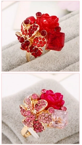 Detailed macro view of colorful resin flower rings with rhinestones in red and pink