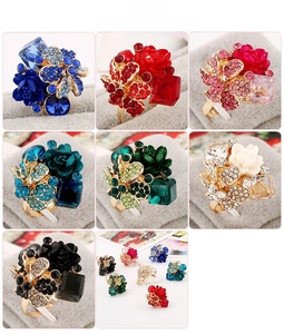 Detailed grid view of colorful resin flower rings with sparkling crystal embellishments