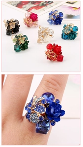 Detail of colorful resin flower rings with crystal rhinestones on alloy base