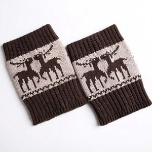 Close-up of thick knitted leg warmers with reindeer jacquard and ribbed cuffs in brown