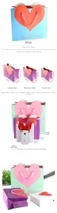 Three sizes of heart-shaped gift bags with love print and rope handles in multiple colors