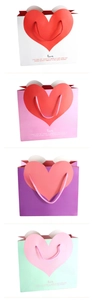 Detailed view of heart-patterned gift bags in white, pink, purple and green colors
