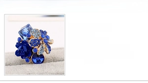 Detailed close-up of blue resin flower ring with crystal inlay and 24mm size dimensions