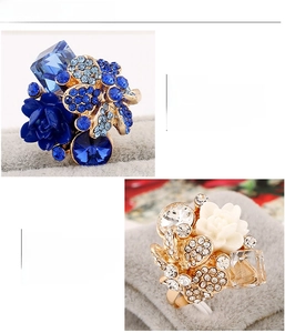 Detail of blue resin floral ring with multi-faceted crystals and gold plated setting