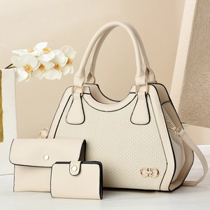 Three-piece beige tote bag set with woven leather texture and elegant metallic logo charm