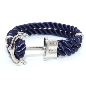 Detail of navy blue braided rope with a polished silver anchor clasp for nautical style