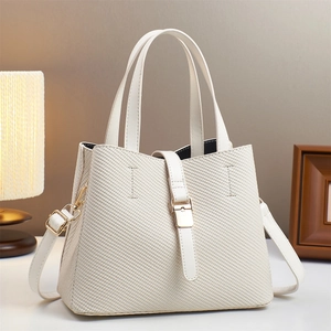 White woven tote bag with adjustable shoulder strap and gold buckle for daily commuting