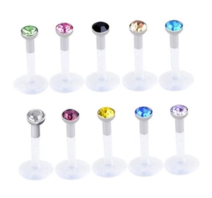 Close-up of 10-piece flexible acrylic labret set with colorful rhinestone stud tops