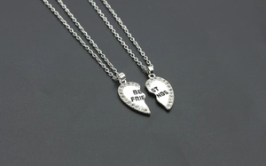 Detail of silver heart-shaped split pendants with rhinestones and Best Friends engraving