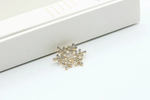 Macro shot of sparkling crystal snowflake brooch on a white gift box display