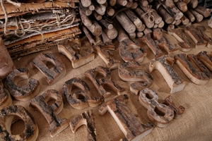 Close-up of vintage wooden letters and numbers with natural bark texture for DIY decor