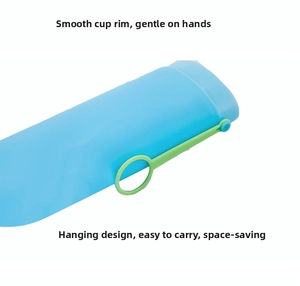 Detail of blue portable toothbrush case with smooth rim and green hanging loop