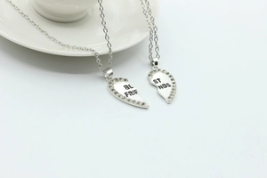 Close-up of silver broken heart necklaces with rhinestones and Best Friends engraving