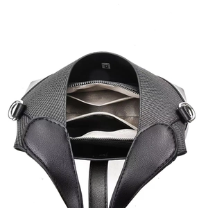 Detail of the handbag interior featuring multi-compartment dividers and silver hardware