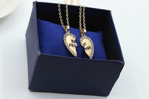 Detailed view of Best Friends heart-shaped gold necklace set with rhinestones in a gift box