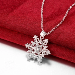 Exquisite silver snowflake pendant necklace with sparkling cubic zirconia on red silk